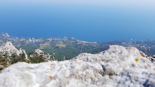 Tilt-shift image of mountain against clear sky