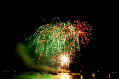 Low angle view of firework display against sky at night