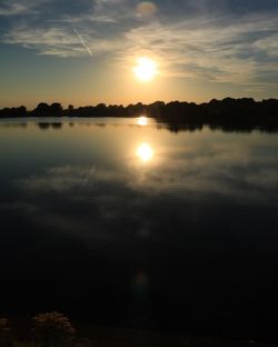 Scenic shot of calm lake at sunset