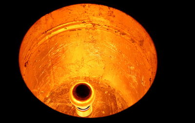 Close-up of illuminated lamp against black background