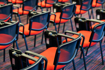 Empty chairs and tables in row