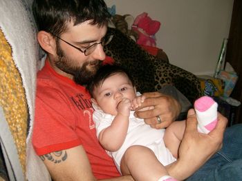 Portrait of father with baby sitting at home