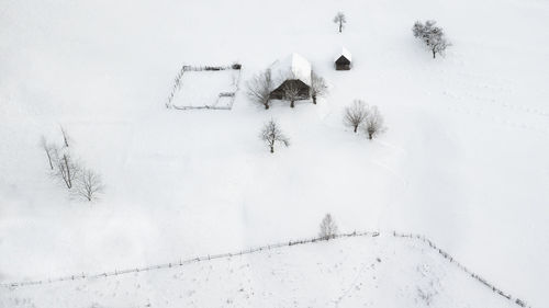 Snow covered field by building