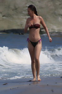 Full length of young woman standing on beach