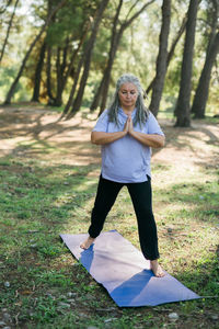 Full length of young woman standing in park