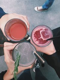 Cropped image of friends toasting cocktails outdoors