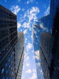 Low angle view of modern building against blue sky