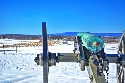 Scenic view of snow covered field against clear blue sky