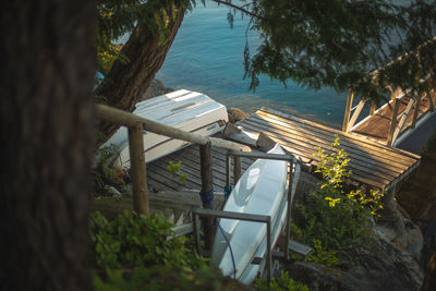 High angle view of boats in lake against trees