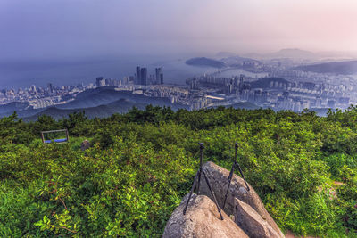 Scenic view of city and mountains against sky