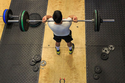 High angle view of a man exercising with barbell