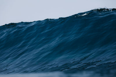 Close-up of sea against clear blue sky