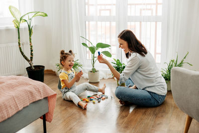 Mom and little daughter choose colorful plasticine for the game. the concept of preschool.