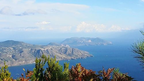 Scenic view of mountains against cloudy sky