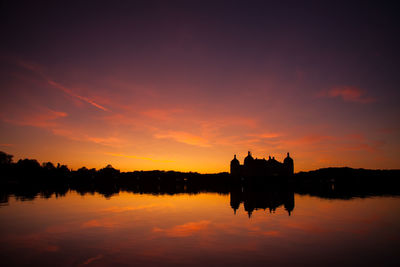 Scenic view of lake against romantic sky at sunset