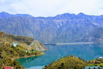 Scenic view of lake and mountains against sky