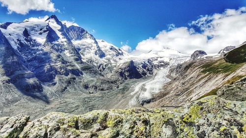 Scenic view of snow capped mountains against sky