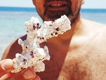 Close-up of man holding coral