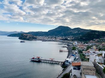 High angle view of townscape and sea against sky