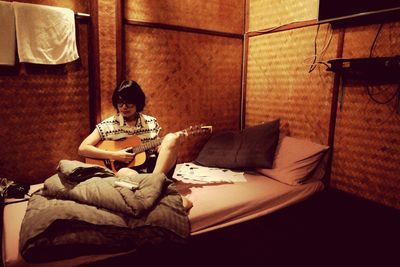 Boy sitting on sofa at home