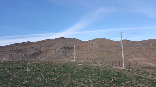 Scenic view of mountains against blue sky