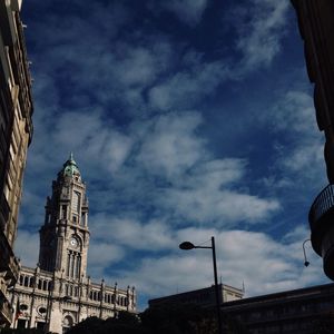 Low angle view of building against cloudy sky