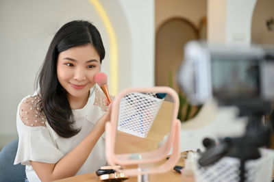 Portrait of young woman using digital tablet