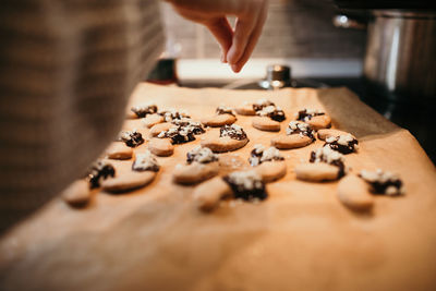 Midsection of person preparing cookies on table