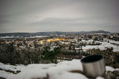 Aerial view of townscape against sky during winter