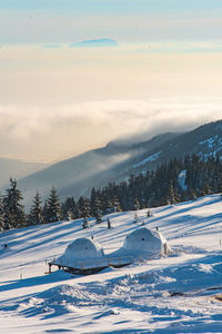 Scenic view of snow covered mountains against sky