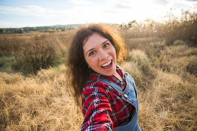 Portrait of smiling young woman on field
