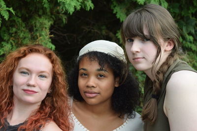 Portrait of friends at grassy field