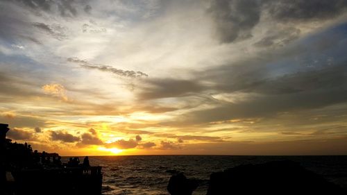 Scenic view of sea against cloudy sky