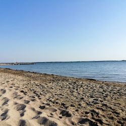 Scenic view of beach against clear sky