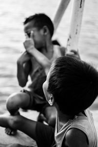 Close-up of boy sitting outdoors