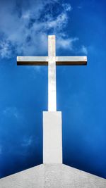 Low angle view of cross against blue sky