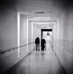 Rear view of woman walking in tunnel