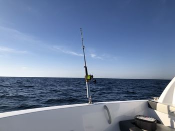 Sailboat on sea against blue sky