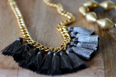 Close-up of necklace on wooden table