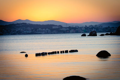 Scenic view of sea against orange sky