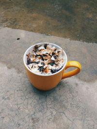 High angle view of coffee in cup on footpath