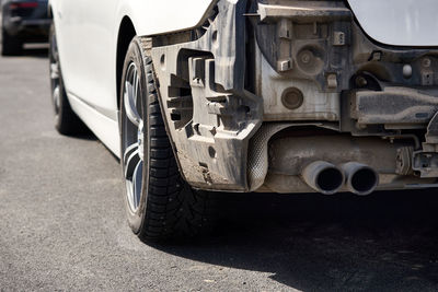 Close-up of car parked on road