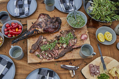 Summer barbecue spread with steak, venison and chimichurri