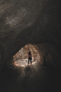 Full length of woman standing in cave