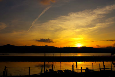 Scenic view of lake against sky during sunset