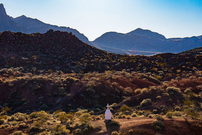 Rear view of people on mountain against sky