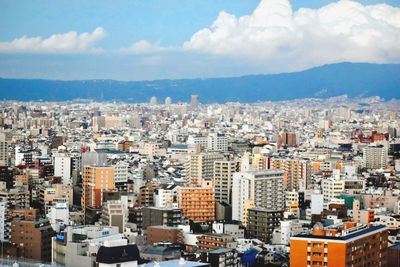 High angle view of buildings in city against sky