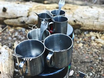 Close up of tin camping cups and sporks in the wilderness.