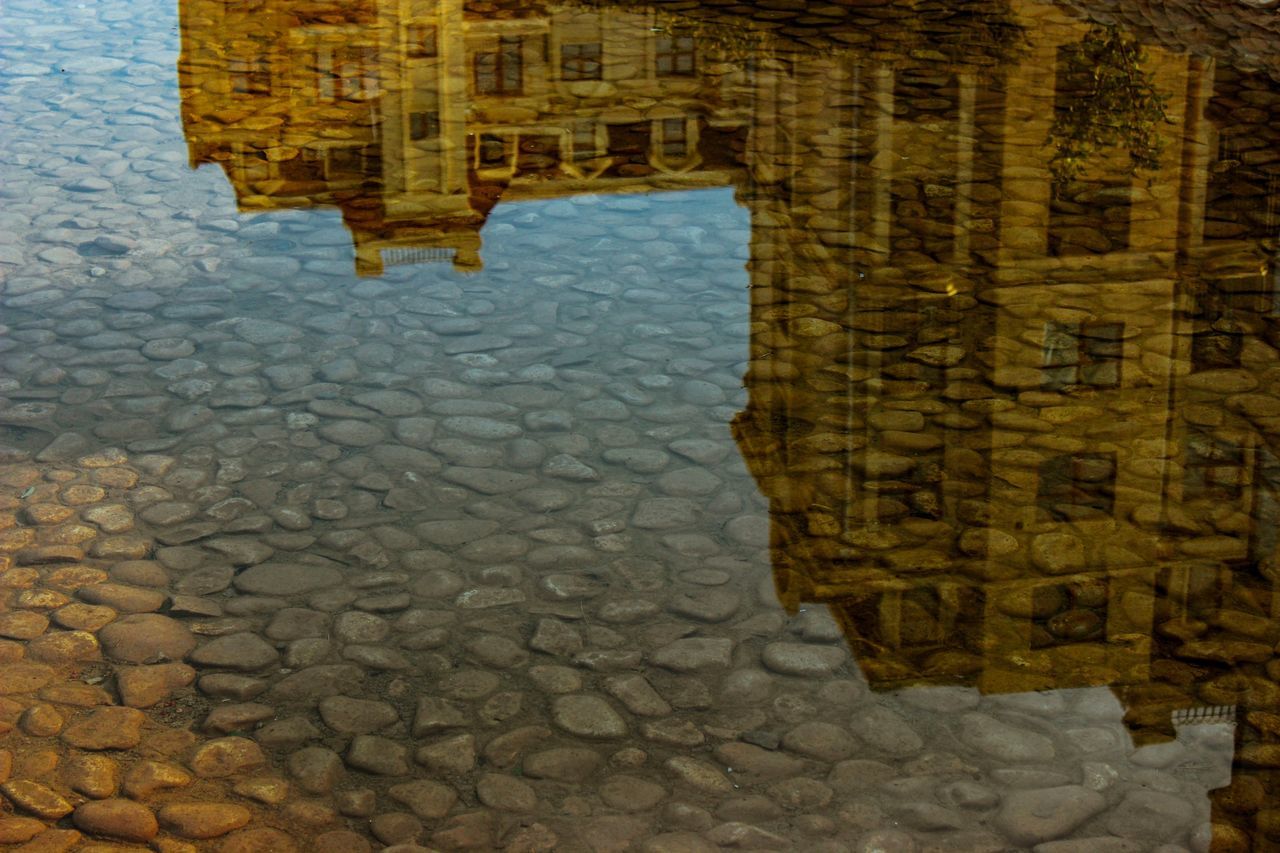 architecture, water, cobblestone, reflection, city, street, puddle, building exterior, no people, nature, built structure, outdoors, day, solid, sky, stone material, stone, travel destinations