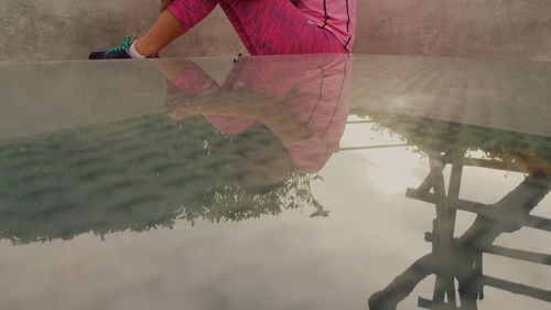 Reflection of woman in puddle